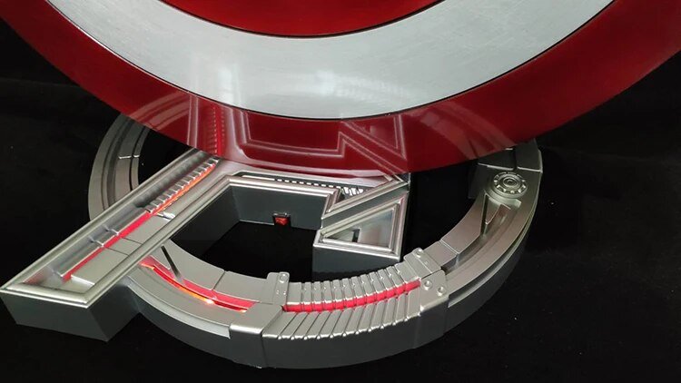 Close-up of Captain America shield resting on lit stand base
