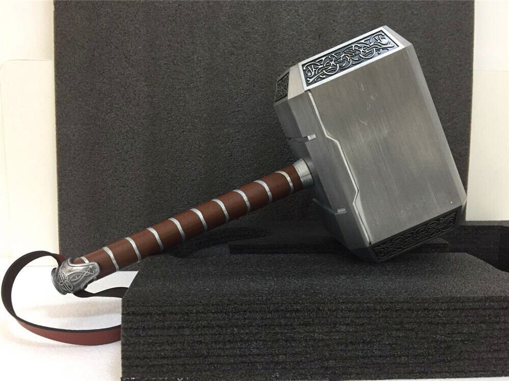 Thor Mjolnir metal hammer replica resting on black foam blocks, angled view