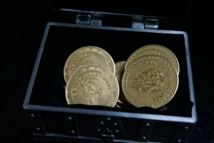 Top view of Warcraft coins inside open treasure chest