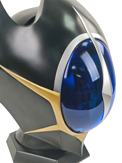 Close-up of Lelouch Zero helmet crown with pointed black fins, blue visor edge, and gold trim