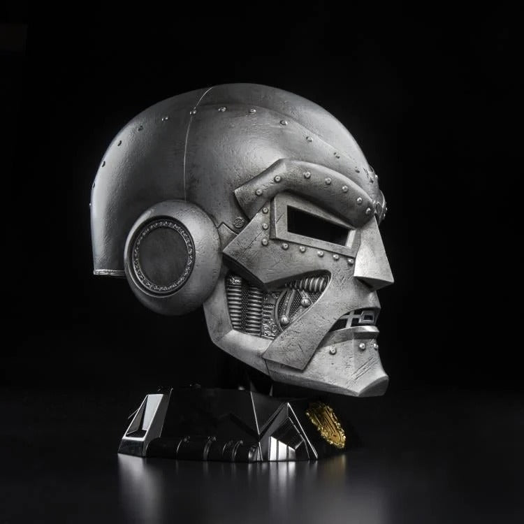 Doctor Doom helmet on display stand against a dark background, side profile