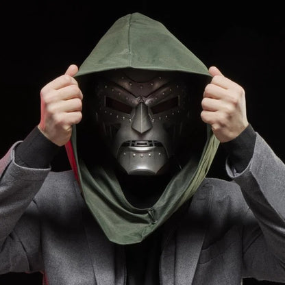 Cosplayer adjusting green hood over Doctor Doom helmet