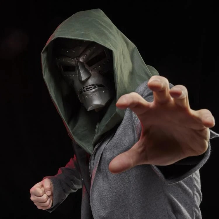 Cosplayer wearing hooded Doctor Doom helmet with reaching hand