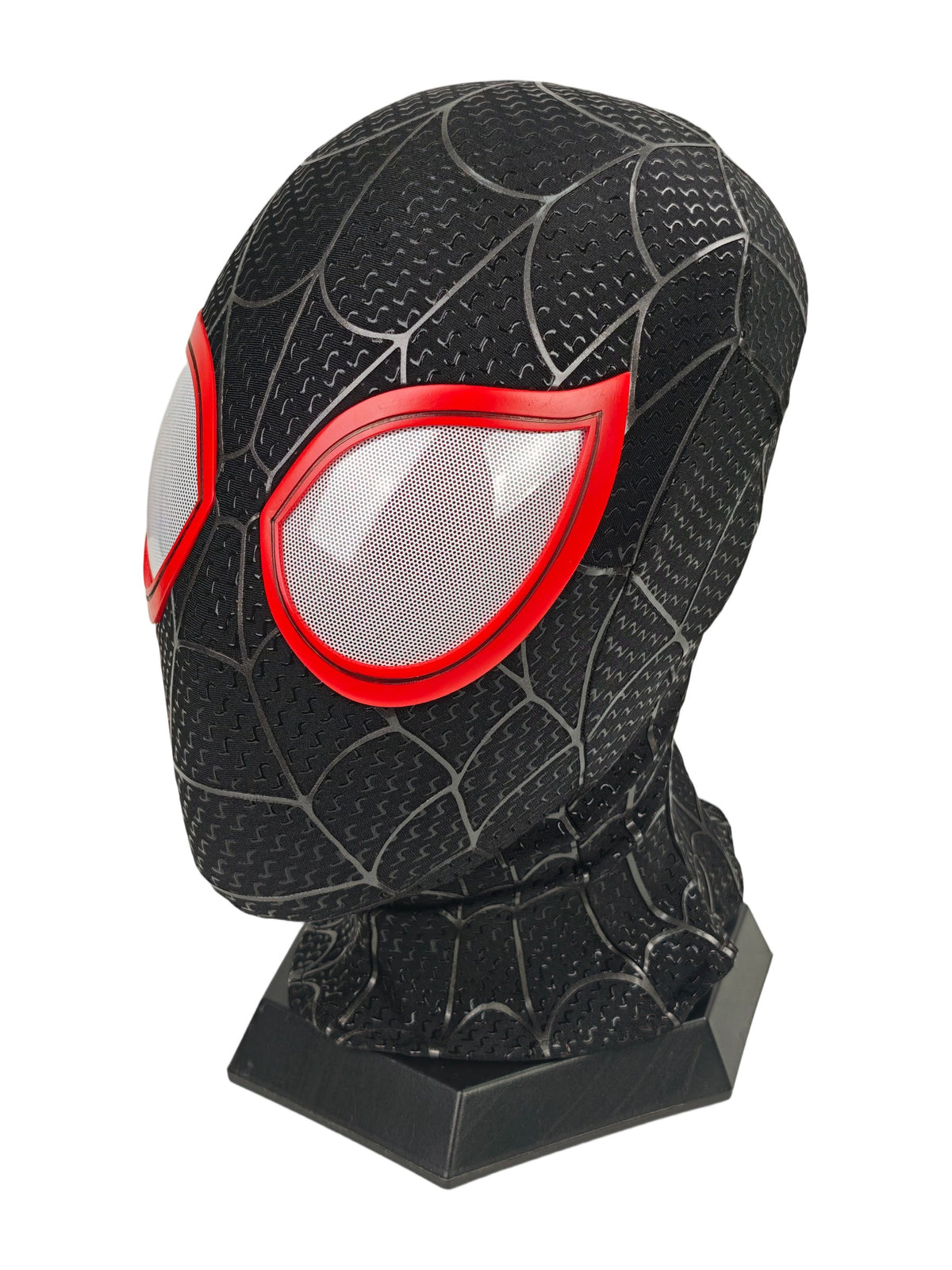 Miles Morales black Spider-Man mask three-quarter view with red eye frame, white mesh lens, web texture, and stand