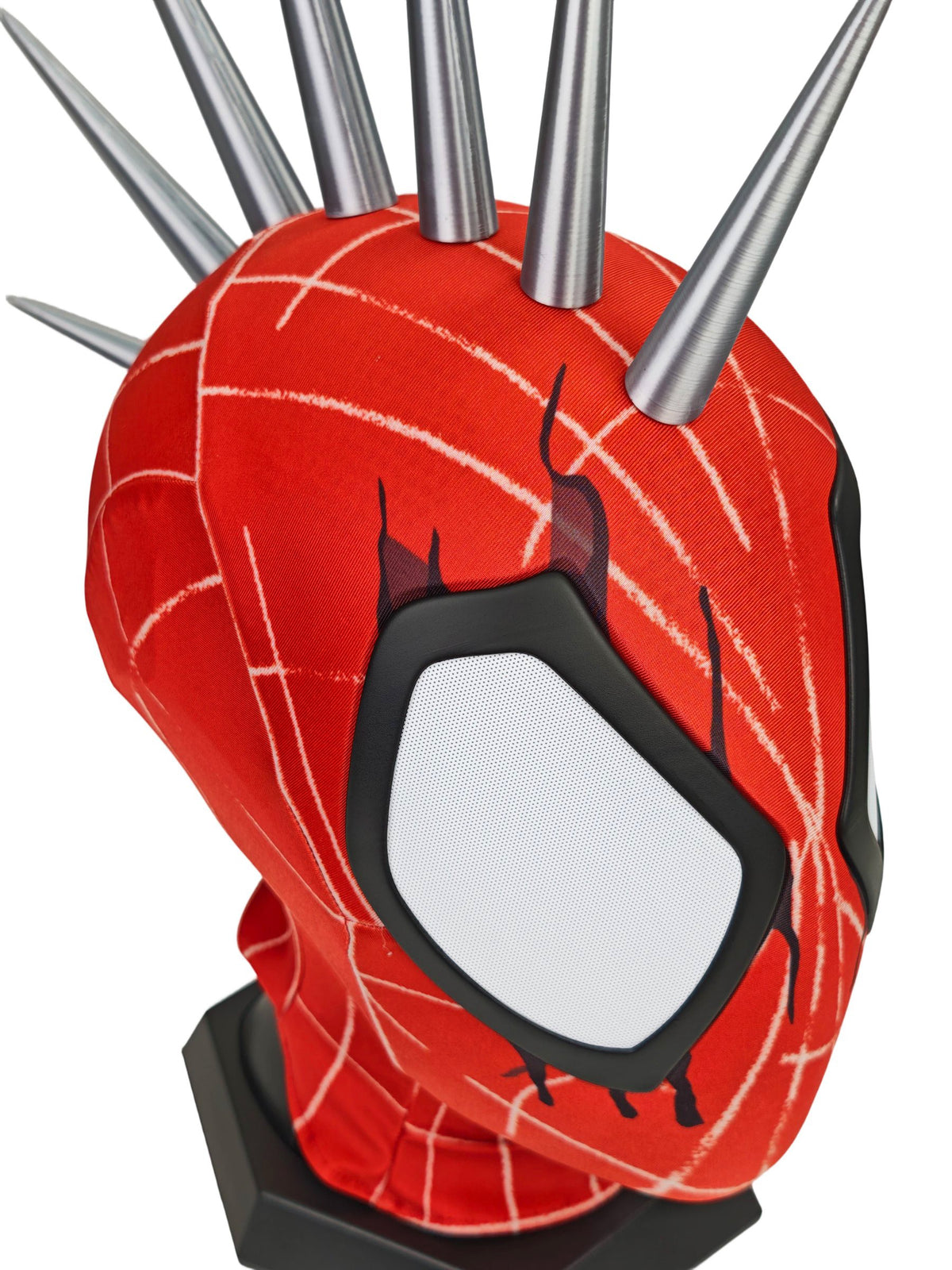 Punk Spider mask with white eye area, white web lines, and multiple silver spikes on top, displayed on a black stand against a white background.