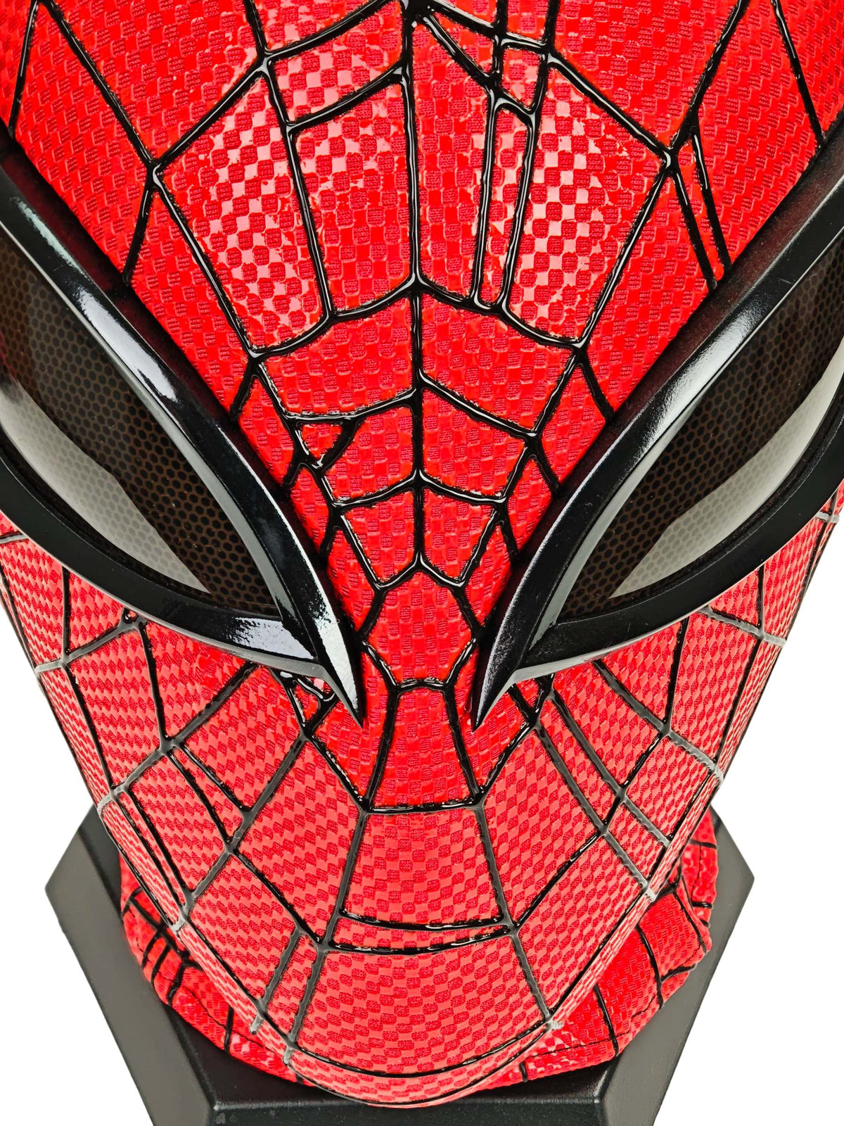Close-up of red checkered fabric, raised black webbing, and dark mesh eye lens on Superior Spider-Man mask