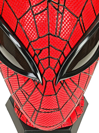 Close-up of red checkered fabric, raised black webbing, and dark mesh eye lens on Superior Spider-Man mask